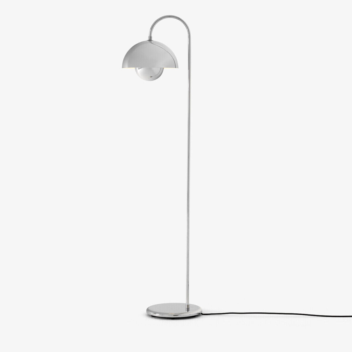 Die Flowerpot VP12 Stehleuchte von &Tradition steht aufrecht mit einem schlanken, verchromten Stahlgestell und rundem Standfuß auf weißem Hintergrund. Der halbkugelförmige Lampenschirm aus Chrom sitzt elegant an einem gebogenen Arm. Schwarzes Textilkabel sichtbar am Boden.