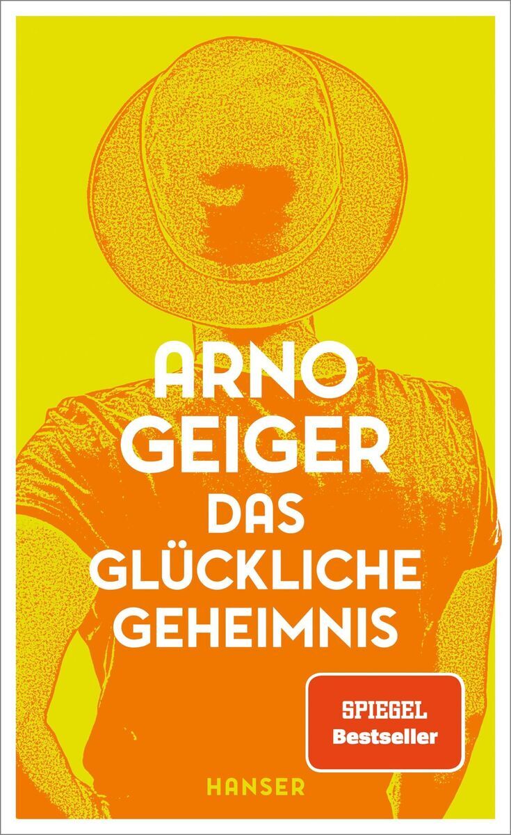 Buchcover des Buches 'Das glückliche Geheimnis' von Arno Geiger, gelbes und oranges Design mit Silhouette einer Person von hinten. Der Titel ist in weißen Buchstaben geschrieben, darunter ein rotes Label 'Spiegel Bestseller'.