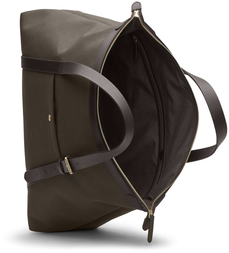 Reisetasche »HOLDALL« in den Farben Oliv und Braun, offen dargestellt. Die Tasche besitzt robuste Lederakzente und ist geräumig mit einem großen Hauptfach und einem zusätzlichen Innenfach. Geeignet für Reisen und Kurztrips, bietet sie sowohl Stil als auch Funktionalität.