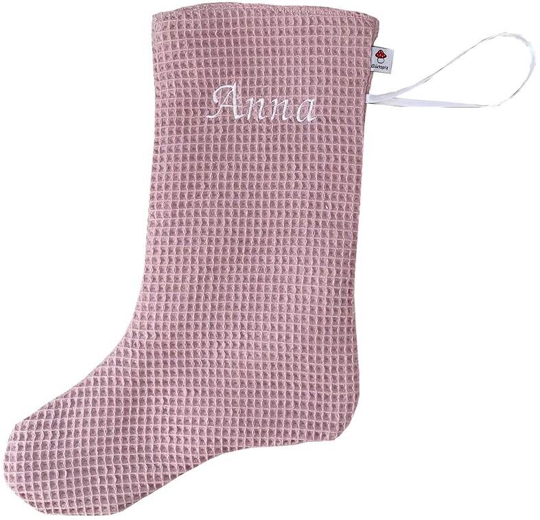 Eine rosa Nikolaussocke mit weißer Stickerei des Namens 'Anna' und einer weißen Schlaufe zum Aufhängen.