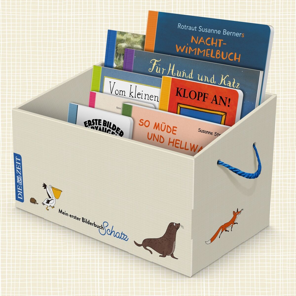 Weiße Box mit blauer Aufschrift 'Mein erster Bilderbuchschatz' und Illustrationen von Tieren. Die Box enthält mehrere bunte Kinderbücher mit Titeln wie 'Nacht-Wimmelbuch', 'Für Hund und Katz', 'KLOPF AN!', 'Vom kleinen Maulwurf', 'Erste Bilder Märchen', 'So müde und hellwach'.