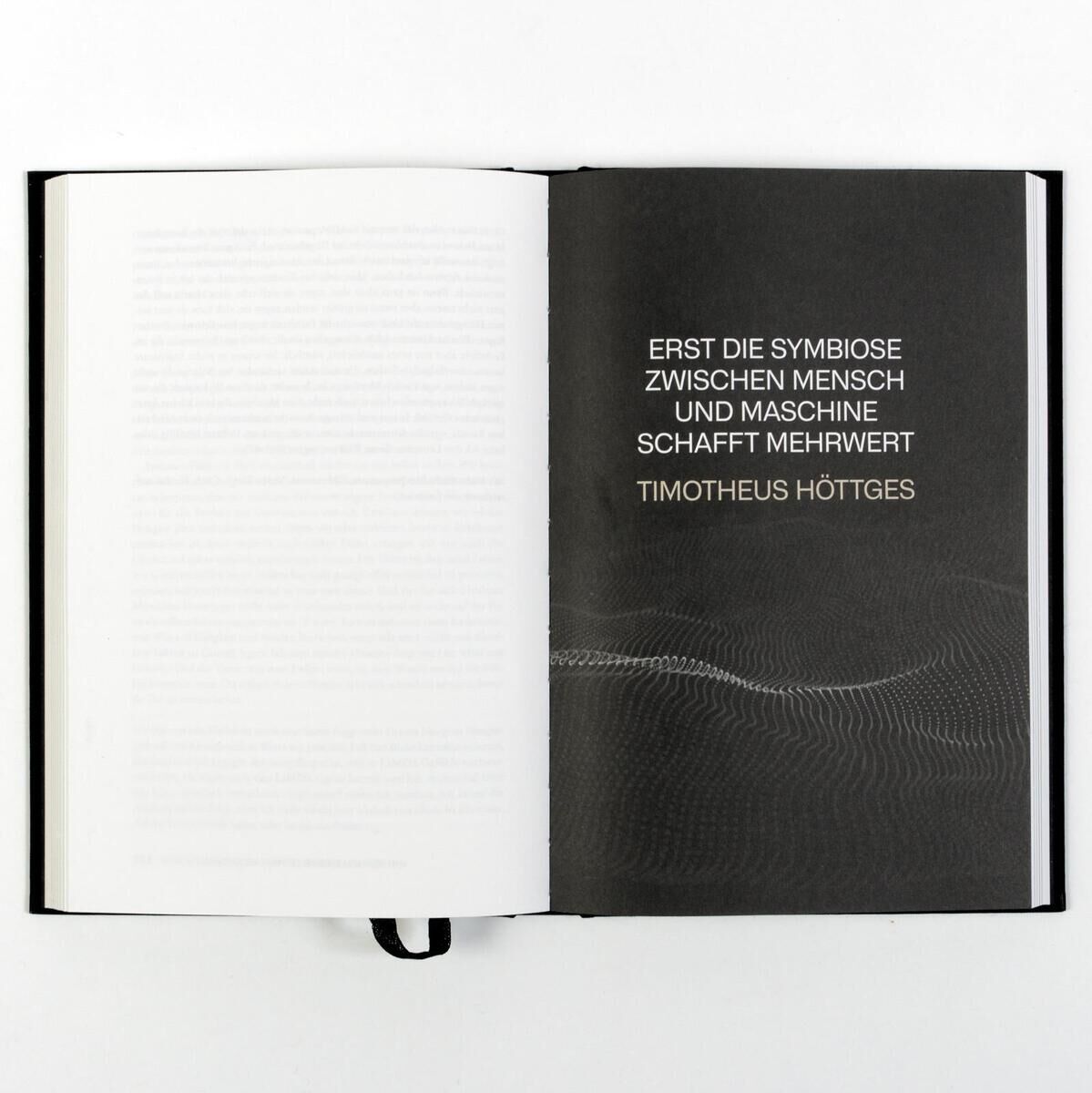 Das Bild zeigt ein aufgeschlagenes Buch mit dem Titel 'Von Artificial zu Augmented Intelligence'. Auf der rechten Seite steht der Text: 'Erst die Symbiose zwischen Mensch und Maschine schafft Mehrwert' von Timotheus Höttges. Der Hintergrund ist schlicht und in Schwarz- und Grautönen gehalten.