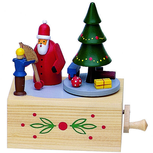 Abgebildet ist eine handgefertigte Musikdose aus Holz mit einem Weihnachtsmann, einem Weihnachtsbaum, Geschenken und einer kleinen Figur. Die Dekoration ist bunt bemalt und zeigt weihnachtliche Motive auf einer rechteckigen Holzbasis mit Ziermuster und Drehgriff.