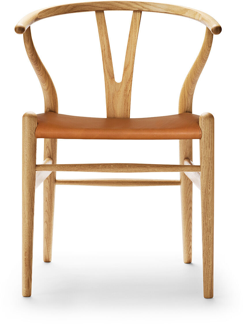Stuhl in skandinavischem Design mit Holzrahmen und Ledersitz in Braun. Der Stuhl zeigt die charakteristische Wishbone-Form und besteht aus Eiche.