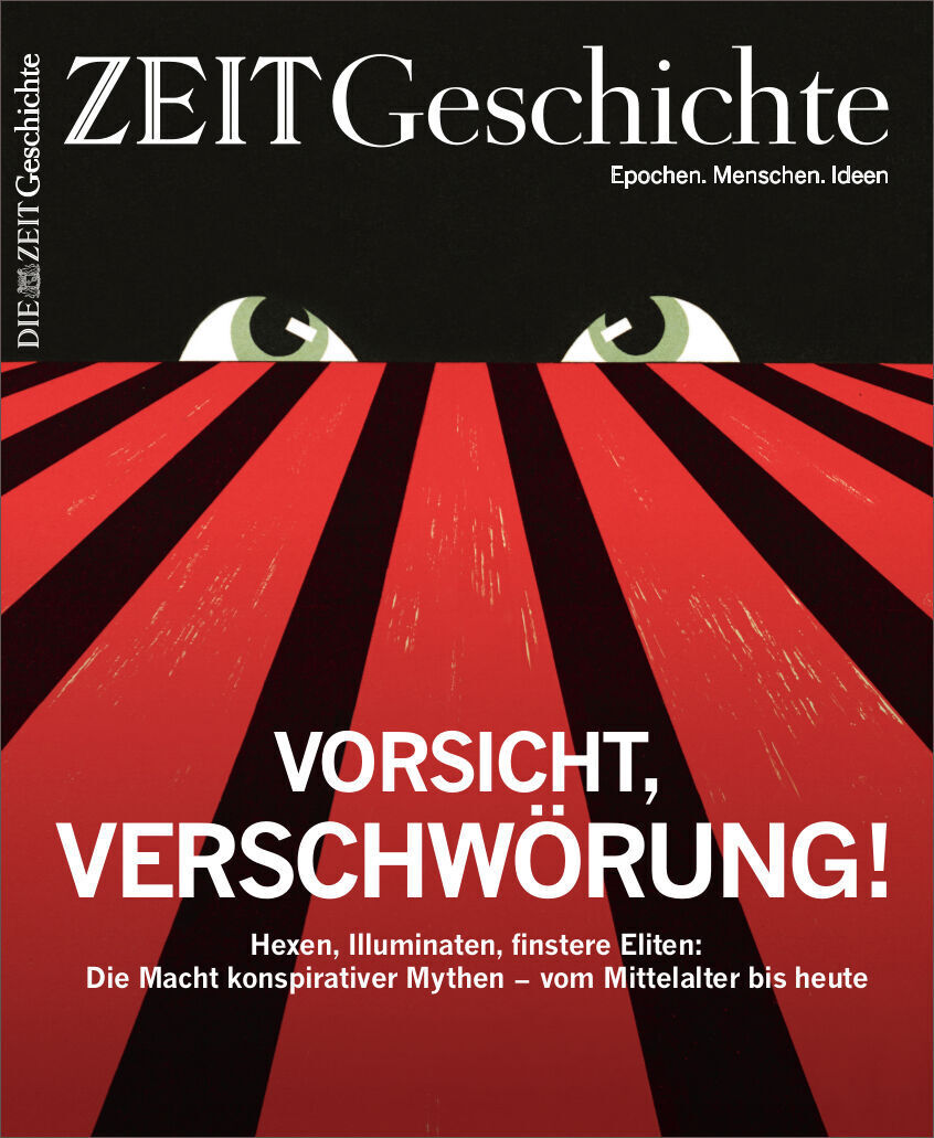 Das Cover des Magazins ZEIT Geschichte mit dem Titel 'Vorsicht, Verschwörung!'. Das Design zeigt ein auffälliges Rot-Schwarz-Weiß-Layout mit grimmig blickenden Augen über einem roten Hintergrund, der Strahlen nach unten verbreitet.