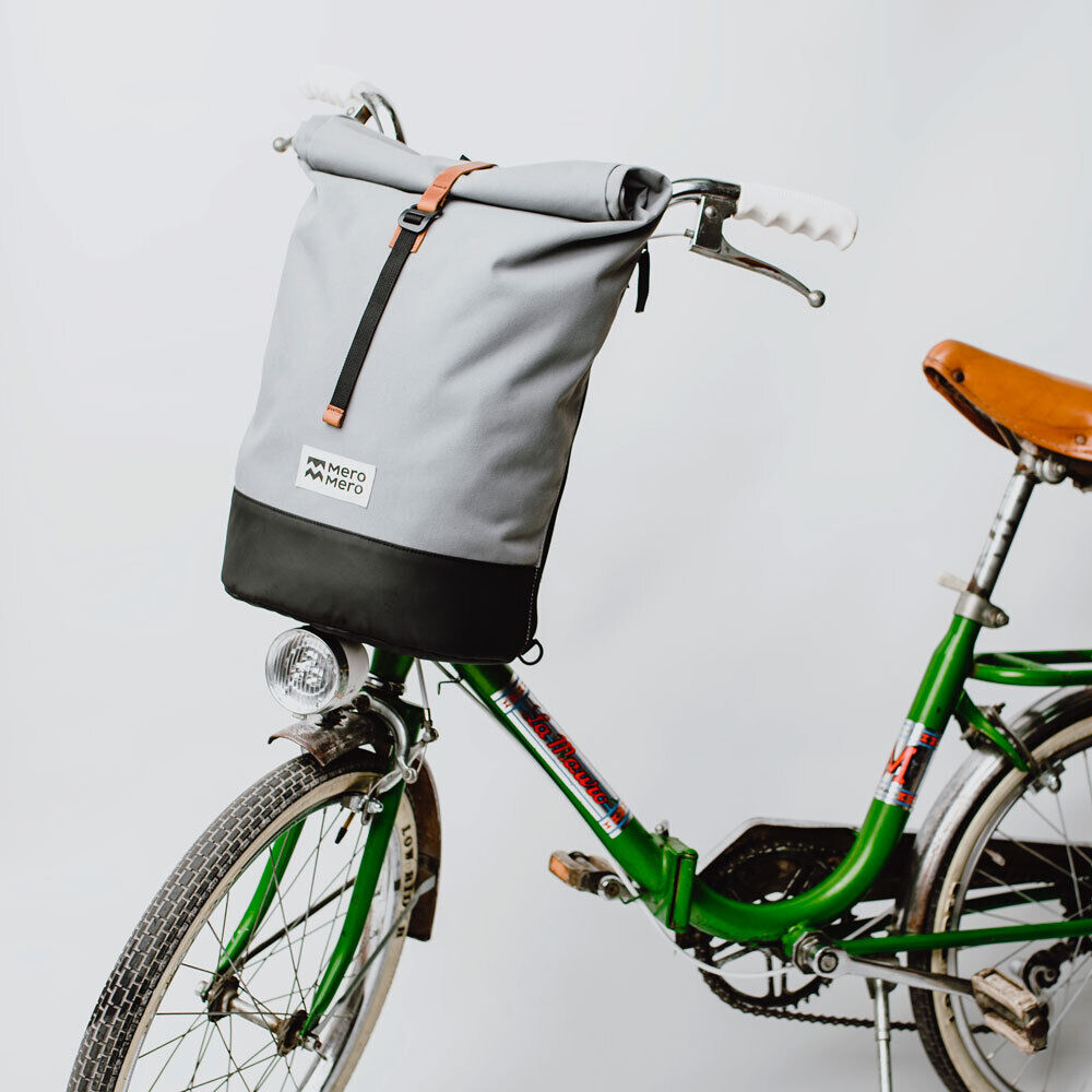 Grau-schwarze Fahrradtasche/Rucksack-Combo 'Annecy' von MeroMero, befestigt an einem grünen Fahrrad, auf weißem Hintergrund.