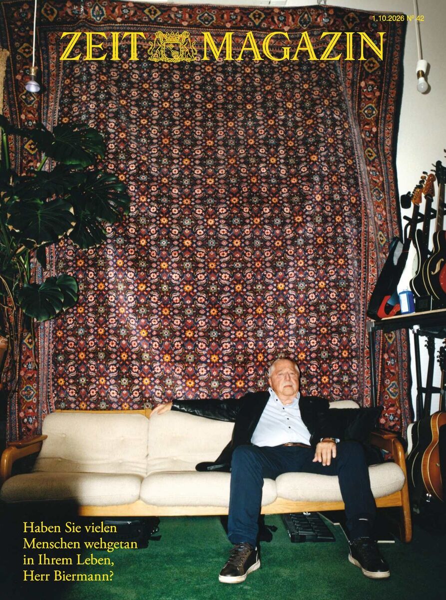 Das Cover des ZEIT Magazins 42/2026 zeigt einen älteren Mann im Anzug auf einem beigefarbenen Sofa vor einem detailreichen Teppich. Links steht eine große Pflanze. Rechts lehnen mehrere Gitarren. Gelber Titeltext. Interviewfrage im gelben Text links unten.