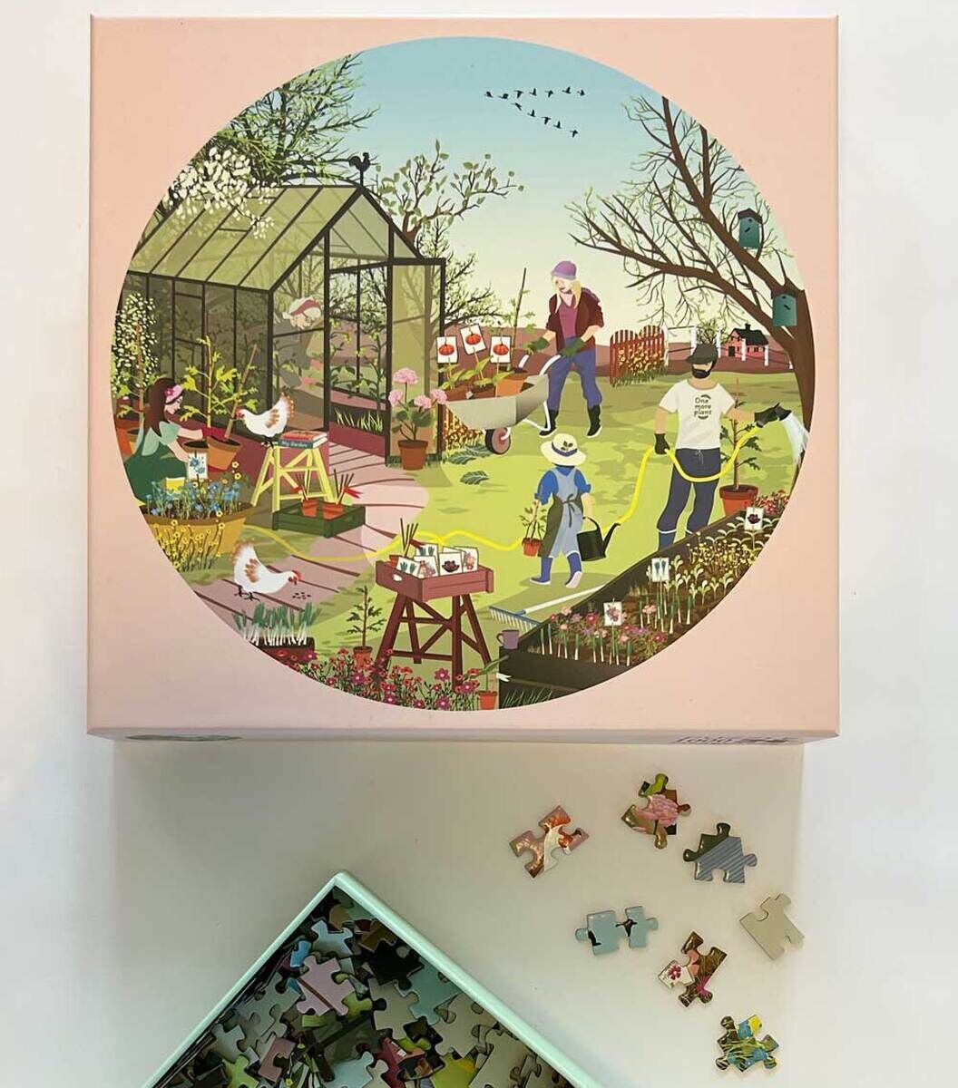 Ein Puzzle mit dem Titel 'Spring Feeling' zeigt eine idyllische Gartenszene mit Menschen bei der Gartenarbeit, Vögeln und einem Glashaus, umrahmt von Bäumen und Pflanzen. Die Farben sind hauptsächlich grün, blau, rosa, gelb und braun.