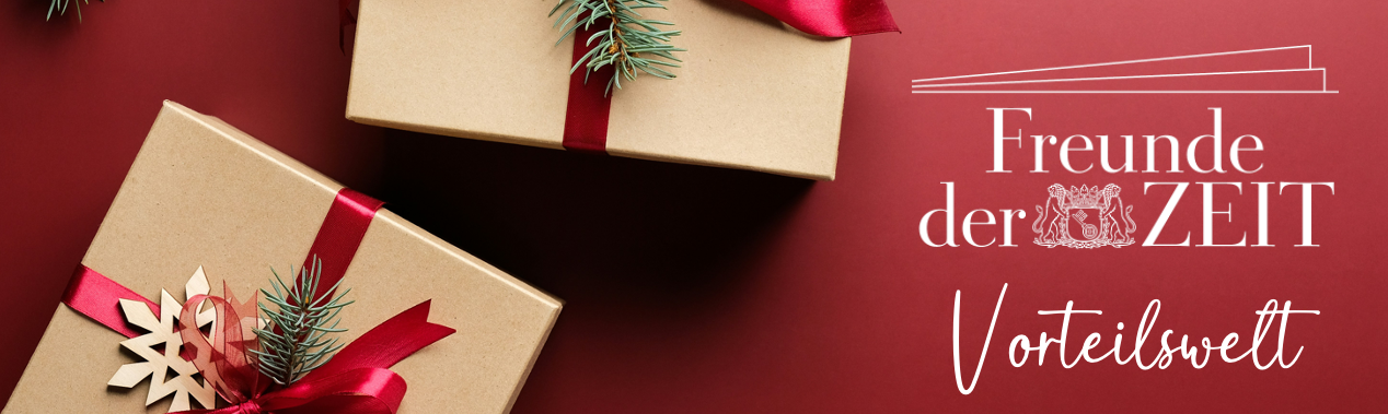 Zwei Geschenkboxen mit roten Bändern und Tannenzweigen auf rotem Untergrund, daneben weißer Text 'Freunde der ZEIT Vorteilswelt'