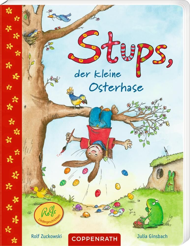 Titelbild des Buches 'Stups, der kleine Osterhase' von Rolf Zuckowski und Julia Ginsbach. Ein Zeichnung eines Hasen, der von einem Baum herunterhängt, mit bunten Ostereiern auf dem Boden. Im Hintergrund eine Landschaft mit Gras, Blumen und einem Haus. Am linken Rand eine rote Leiste mit gelben Blumenmuster.