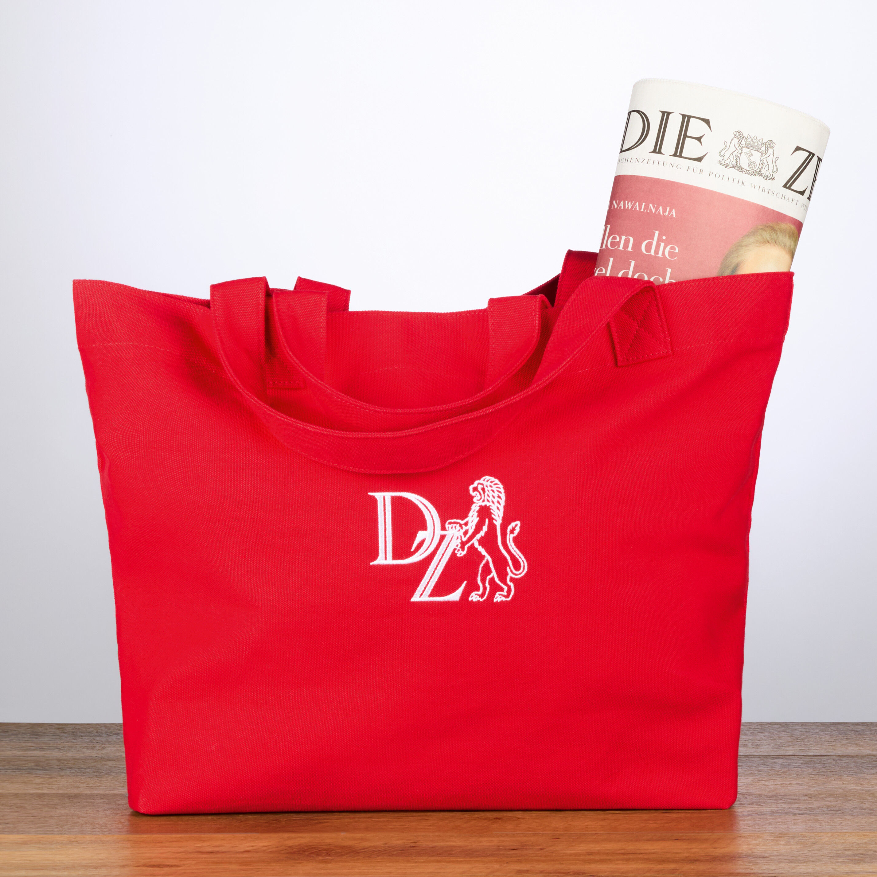 Korallenrote Canvas-Tasche mit einem weißen Logo-Aufdruck der 'ZEIT', perfektioniert als modisches und praktisches Accessoire für den Alltag, umweltfreundlich und geräumig.