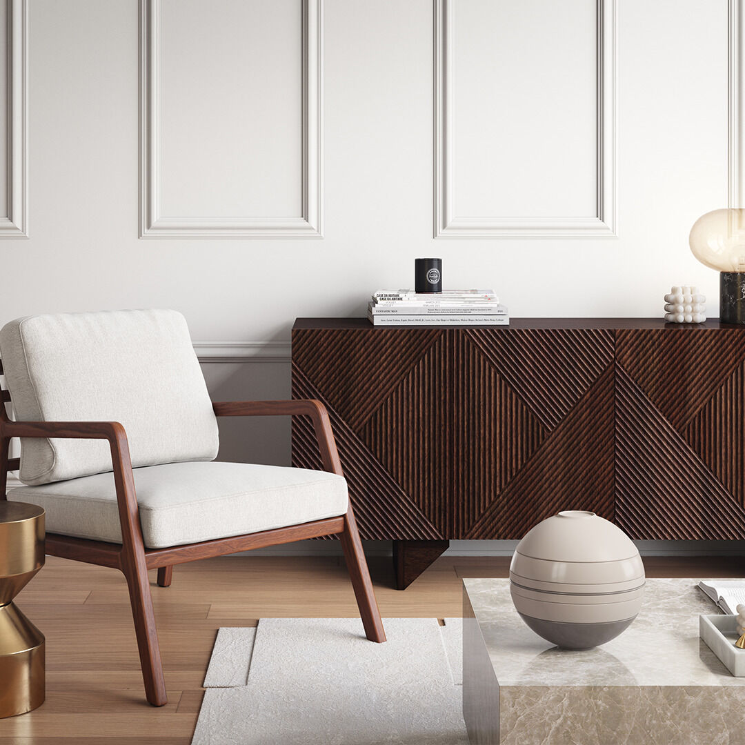 Eine Szene in einem modernen Wohnzimmer mit einem »La Boule« Geschirr-Set in Beige und Weiß auf einem Marmortisch. Daneben steht ein stilvoller Sessel mit weißen Polstern und hölzernen Armlehnen, sowie ein elegantes Sideboard aus dunklem Holz mit geometrischen Mustern.