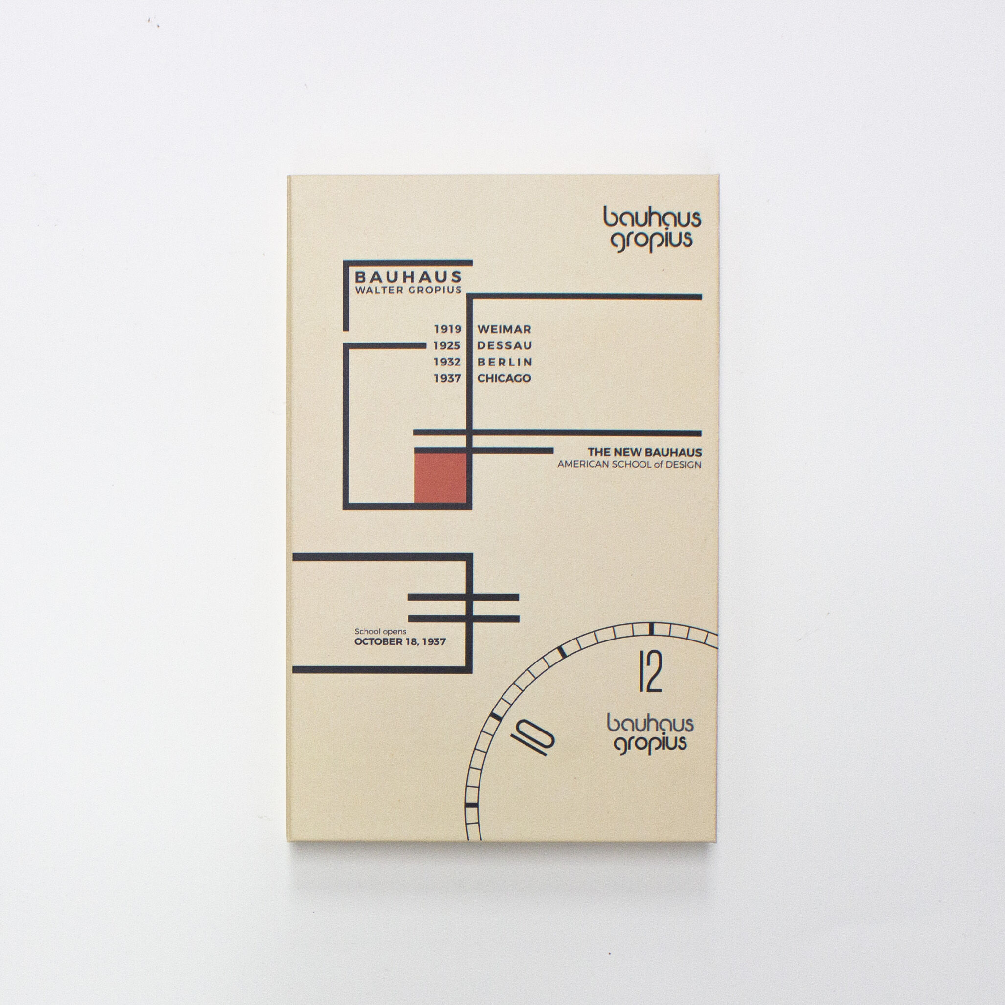 Vorderseite einer Verpackung der ZEIT-Sonderedition Walter Gropius Armbanduhr »New Bauhaus Chicago 1937«. Das Design zeigt grafische Elemente im Bauhaus-Stil mit geometrischen Linien, Rechtecken und Kreisen in Beige, Schwarz und Rot. Die Aufschrift nennt Standorte wie Weimar, Dessau, Berlin und Chicago sowie den Namen Walter Gropius. Das Motiv repräsentiert minimalistisches und modernes Design.