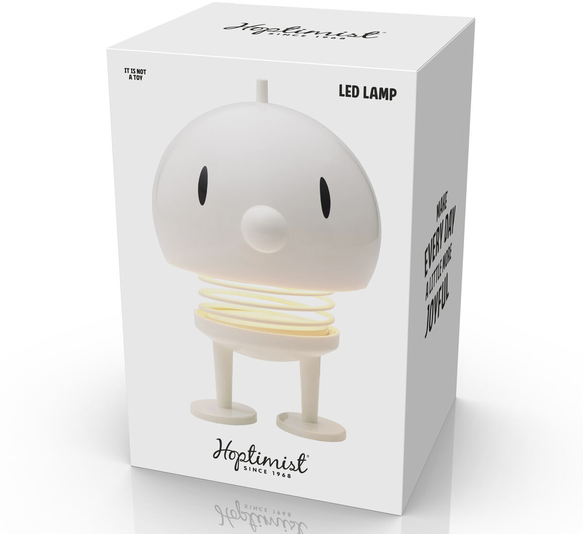 Die Hoptimist LED Lampe in Weiß zeigt eine spielerisch designte Figur in einer Kartonverpackung, die sowohl kindlich als auch modern wirkt. Sie ist eine energiesparende Tischlampe, die sich perfekt als dekorative Beleuchtung für Kinderzimmer eignet.