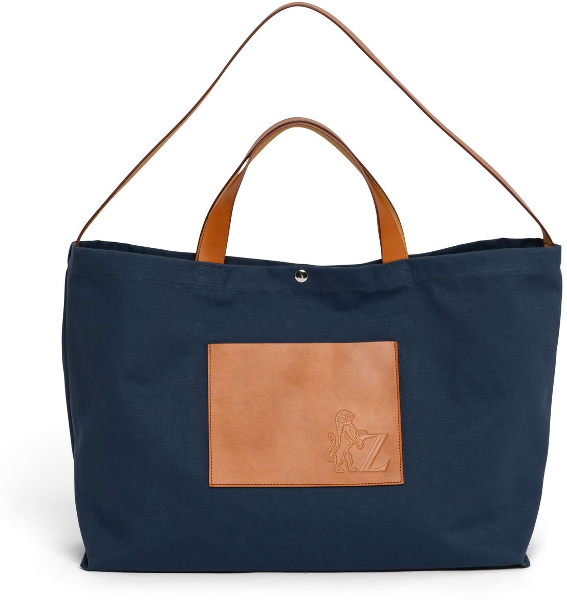 Eine blaue Markttasche mit braunen Ledergriffen und einer braunen Tasche vorne. Sie hat einen einfachen, aber eleganten Look.