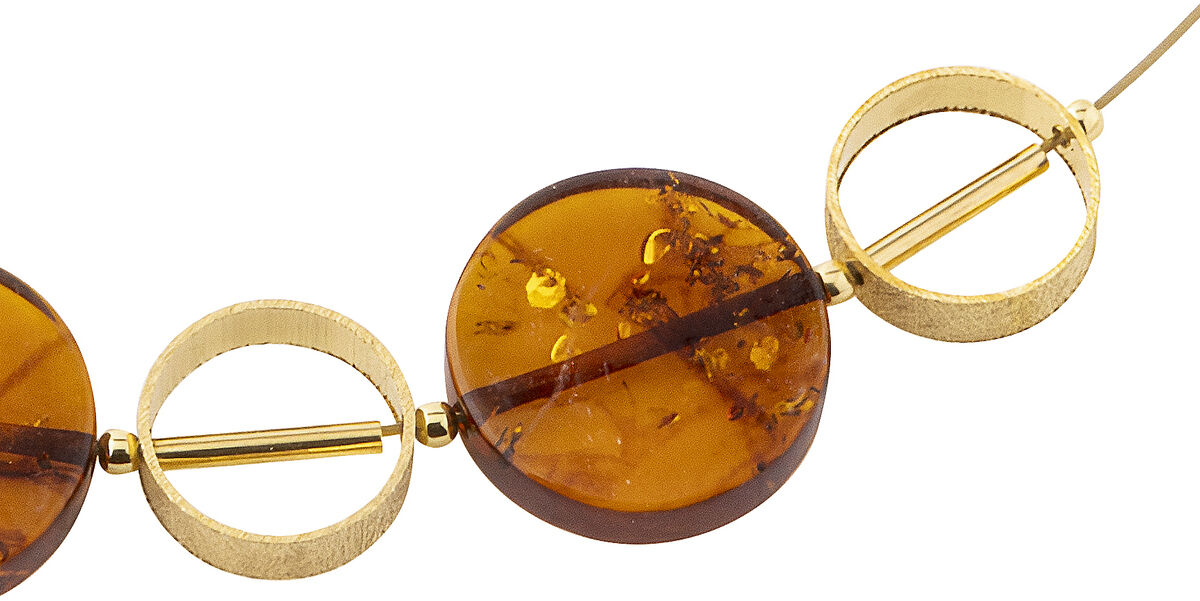 Collier mit vier runden Bernsteinelementen und goldfarbenem Draht in minimalistischer Ausführung, geeignet als eleganter Halsschmuck für Damen.