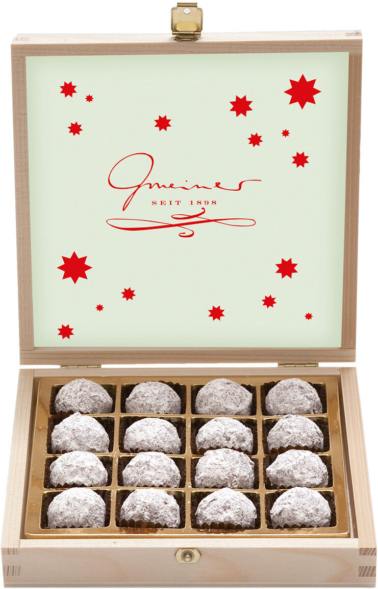 Eine geöffnete Holzbox mit 16 Champagnertrüffeln, arrangiert in einem Raster, mit einem roten Logo und roten Sternen auf der Innenseite des Deckels.