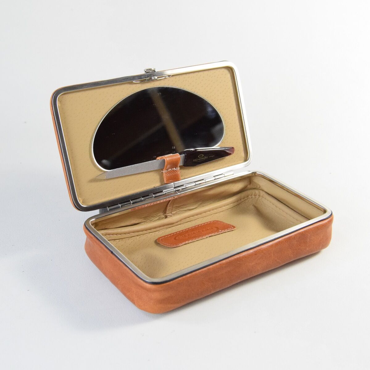 Elegante und schlichte Utensilienbox aus Leder in Braun und Beige. Die Box hat ein silbernes Scharnier und ein geräumiges Innenfach zur Aufbewahrung.