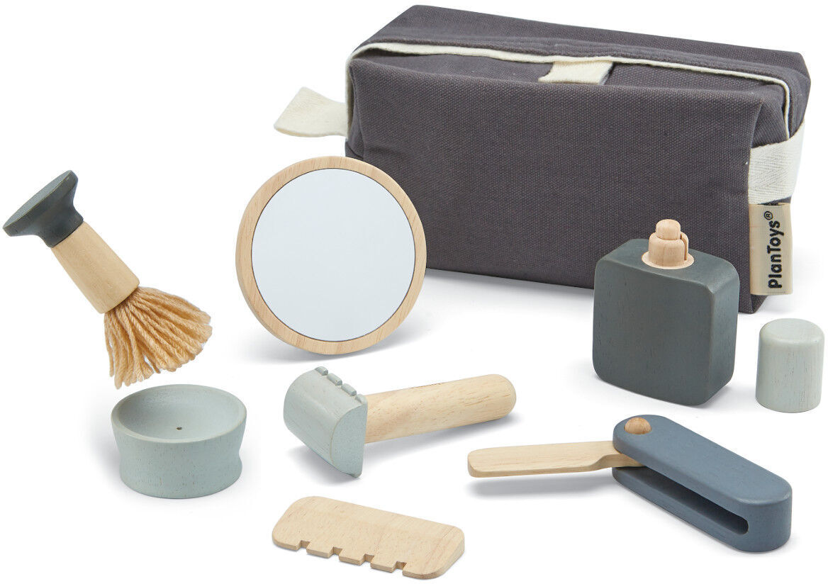 Bild eines Rasier-Sets für Kinder mit verschiedenen Holzspielzeugen wie Pinsel, Spiegel, Rasierer, Kamm und Etui. Alle Artikel sind in neutralen Farben Grau, Weiß und naturbelassenes Holz gehalten.