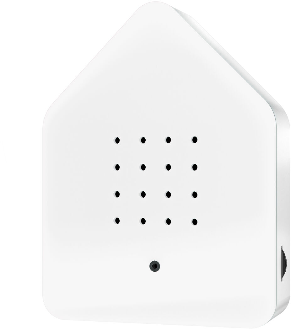Ein Zwitscherbox-Gerät in weiß. Es hat die Form eines Hauses mit abgerundeten Ecken und schwarzen Punkten in einem Gittermuster in der Mitte.