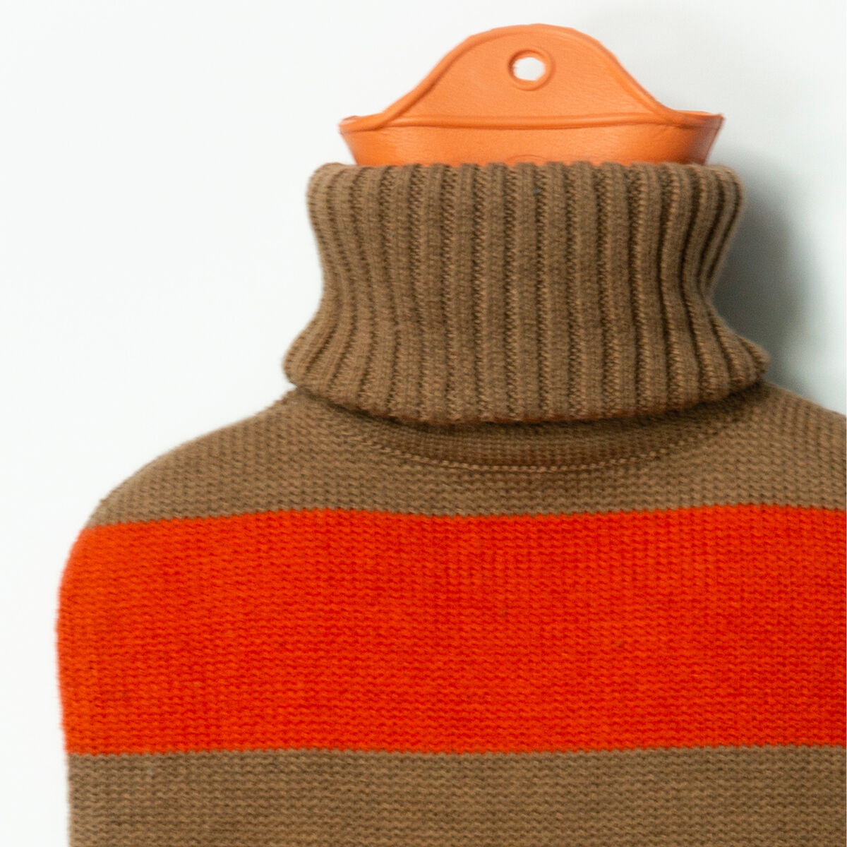 Wärmflasche gestreift Rot von SUITE702, 2 Liter, umhüllt mit weichem, gestricktem Bezug aus 100% Baumwolle in Braun mit auffälligem roten Streifen und breitem Rollkragen. Oberer Flaschenteil in Orange sichtbar, modernes und komfortables Design, auf weißem Hintergrund.
