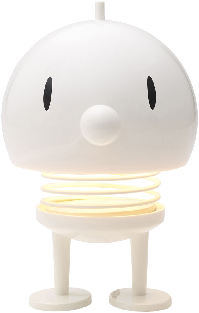 Weiße Hoptimist LED Lampe in Form einer fröhlichen Figur mit runden Augen und einer leuchtenden Spirale als Körper, stehend auf zwei Füßen.