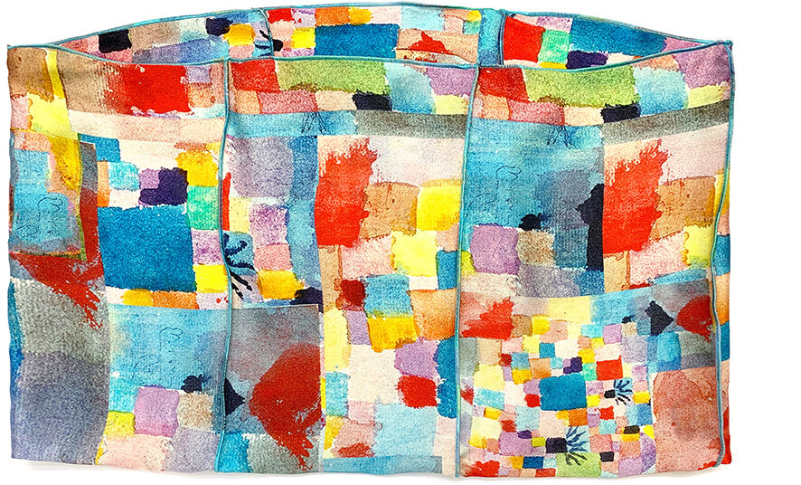 Ein Loopschal, inspiriert von Paul Klees Werk »Südliche Gärten«, zeigt ein lebendiges, abstraktes Muster mit bunten, ineinandergreifenden Farben wie Blau, Rot, Gelb, Grün und mehr. Ideal für Kunstliebhaber als modisches Accessoire.
