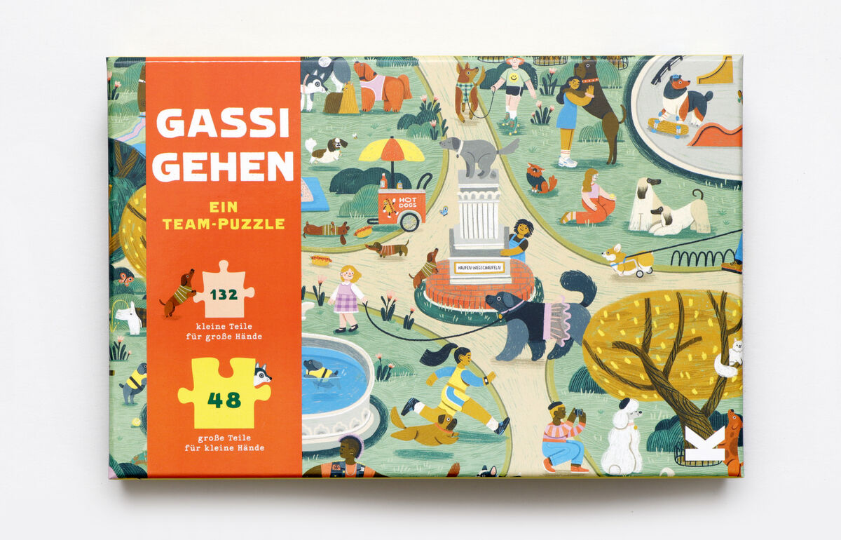 Eine Puzzle-Schachtel mit dem Titel 'Gassi gehen' zeigt eine bunte Illustration eines Parks mit verschiedenen Hunden, Menschen beim Spaziergang und anderen Freizeitaktivitäten. Es enthält 132 kleine Teile und 48 große Teile, geeignet für ein Team-Puzzle.