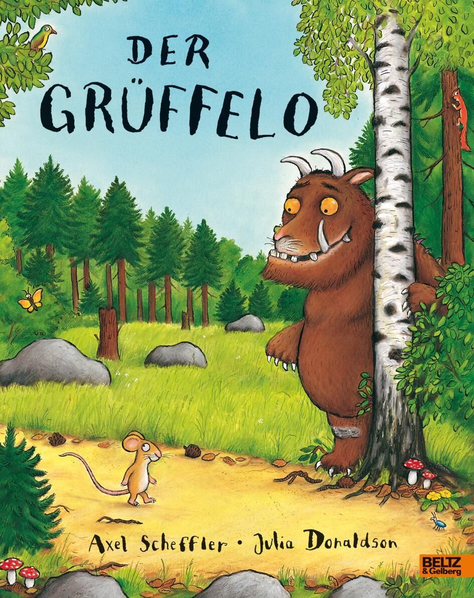Das Buchcover von 'Der Grüffelo' zeigt eine Illustration eines grünen Waldes mit einem braunen Monster, genannt Grüffelo, und einer kleinen Maus, die sich gegenseitig ansehen. Vorne auf dem Cover sind die Namen der Autoren Axel Scheffler und Julia Donaldson abgebildet. Verschiedene Bäume und Steine sind im Hintergrund zu sehen.