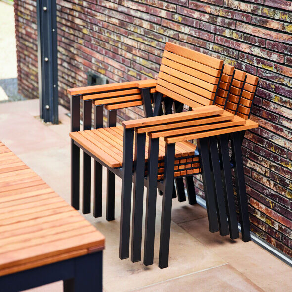 Der »Bozen« Stapelsessel besteht aus einem modernen Design mit braunem Holz und schwarzem Metallrahmen. Er ist stapelbar und ideal für den Außenbereich, z.B. auf Terrassen oder in Gärten, geeignet.