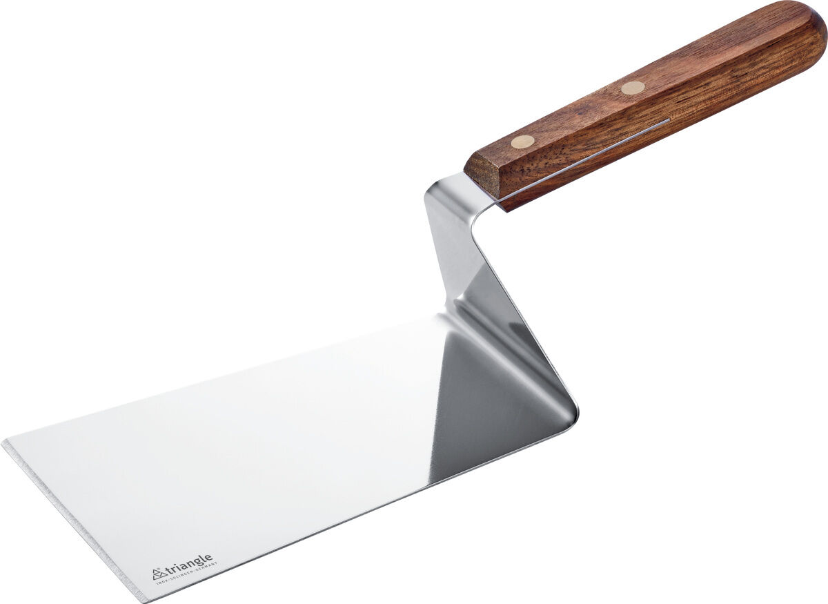 Auf weißem Hintergrund liegt die Plancha Palette von triangle, 15 cm lang, gefertigt aus edlem Nussbaumholz mit silberner Edelstahl-Klinge. Das Holz glänzt samtig dunkel, die Klinge ist flach, matt und rechteckig. Das Werkzeug wirkt hochwertig und modern.