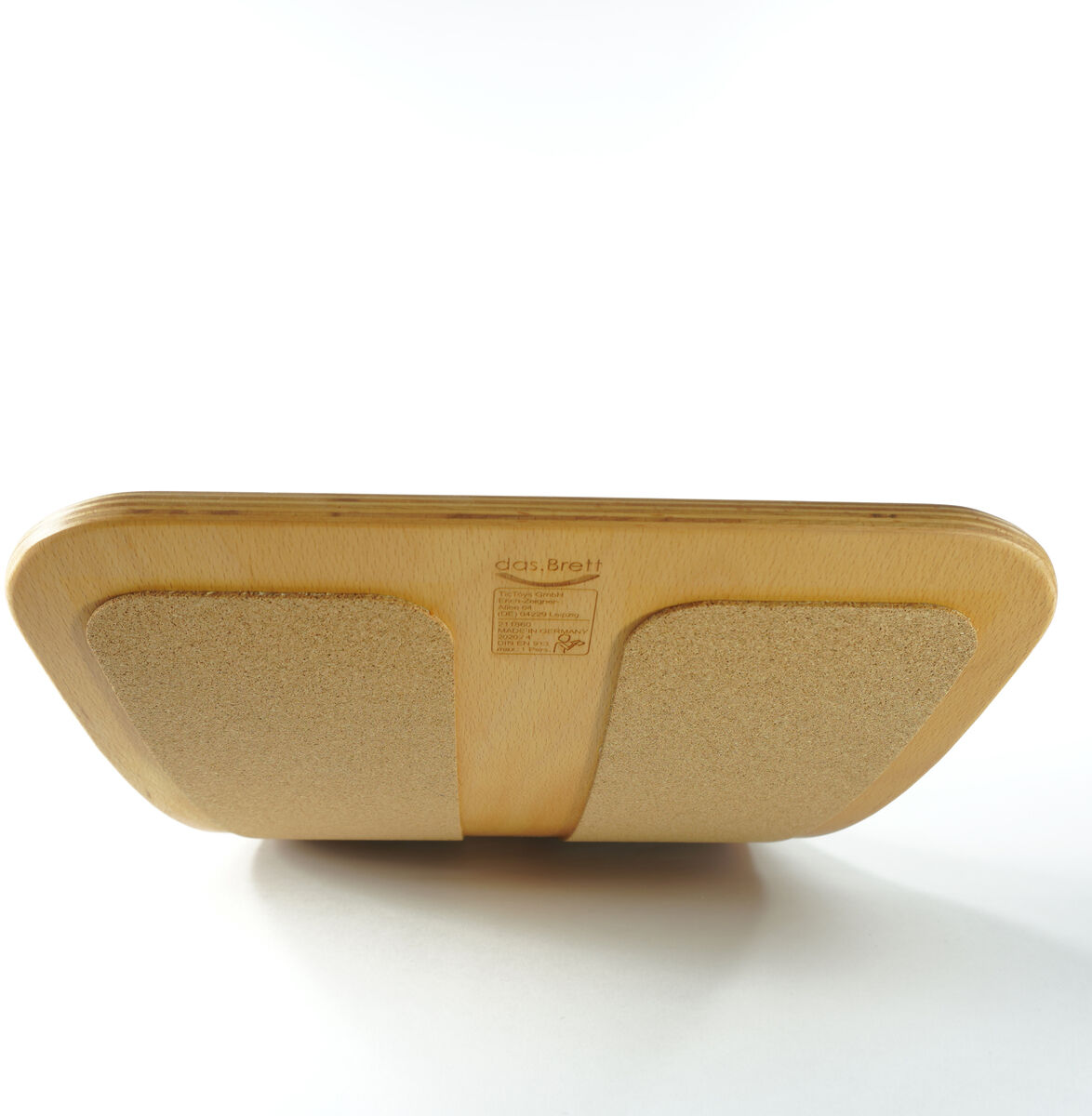 Balance Board »das.Brett«, geölt. Aus Holz, liegend auf einer hellen Oberfläche.