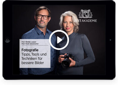 Ein Tablet zeigt die Startseite des »Angewandte Fotografie«-Seminars von ZEIT Akademie. Zwei Moderatoren, ein Mann und eine Frau, sind zu sehen. Der Mann hält eine Kamera und beide blicken direkt in die Kamera.