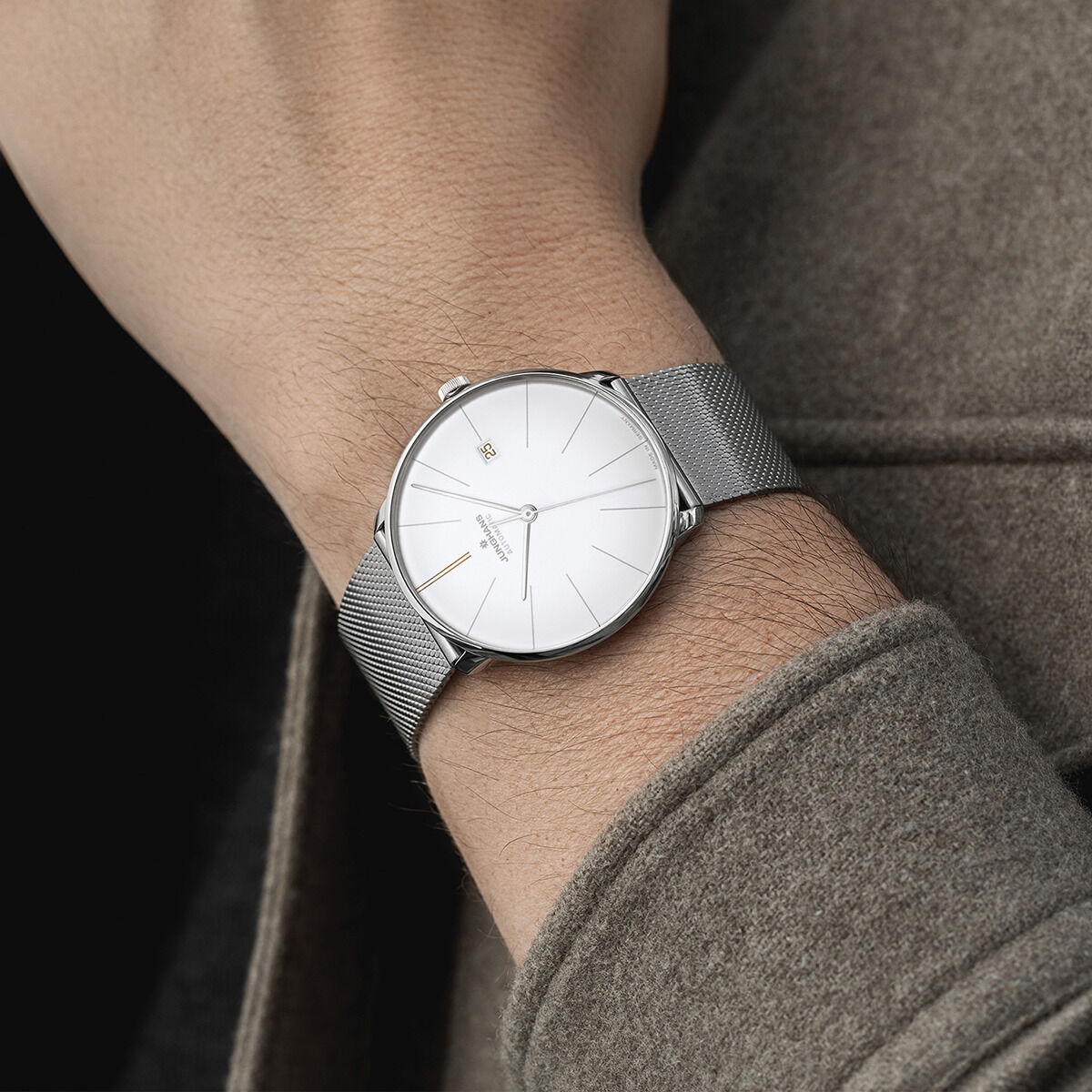 Eine ZEIT-Sonderedition »Meister fein Automatic« von Junghans. Diese Herrenuhr hat ein minimalistisches Design mit einem silbernen Edelstahlarmband und einem weißen Zifferblatt. Sie passt sich elegant an das Handgelenk an und bietet eine klare Zeitangabe.