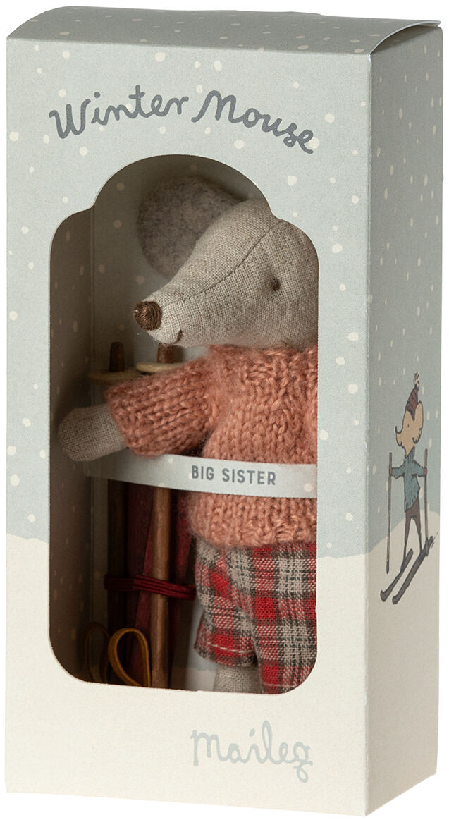 Eine niedliche Wintermaus-Puppe der Marke Maileg in einer Schachtel. Die Puppe trägt einen roten Rollkragenpullover und karierte Hosen, mit Skiern und Skistöcken als Accessoires. Sie ist beschriftet mit 'Big Sister'.