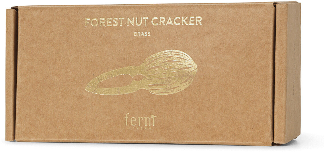 Braune Kartonverpackung mit goldenem Aufdruck eines Nussknackers und der Aufschrift 'Forest Nut Cracker Brass' sowie 'ferm'; minimalistisches, natürliches Design – ideal als Geschenk oder für die festliche Dekoration in der Küche.