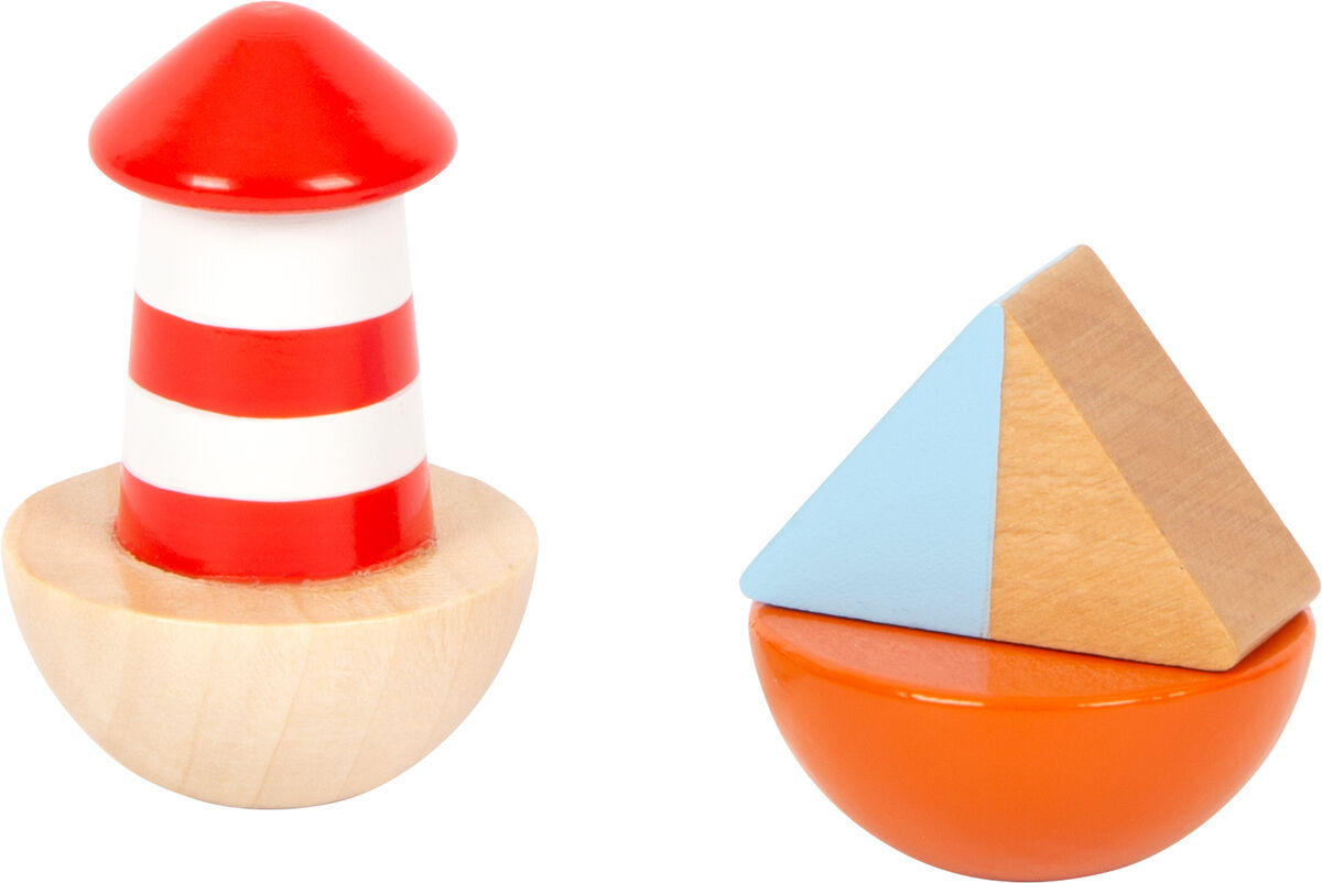 Eine Spieluhr mit dem Namen 'Großer Ozean'. Sie besteht aus zwei Hauptteilen: einem rot-weiß geringelten Leuchtturm auf einem naturholzfarbenen Sockel und einem zusammengesetzten Objekt aus einem orangefarbenen Halbkreis und einer aufgesetzten blau-beigen Pyramide. Das Spielzeug ist farbenfroh und aus Holz gefertigt.