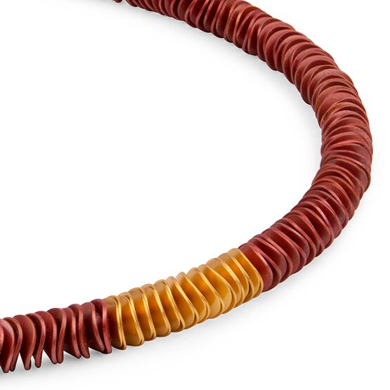 Detailreiches Collier »Natalia« der Marke Zaremski, bestehend aus aneinandergereihten, flachen Kupferscheiben und vergoldeten Silberscheiben. Die Kette hat einen Bajonettverschluss, wirkt edel und handwerklich gefertigt, mit warmen Rot- und Goldtönen.