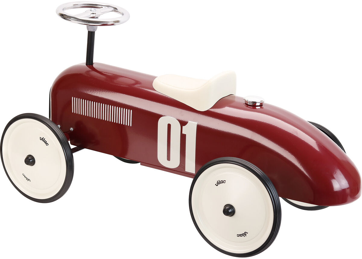 Rotes Vintage-Auto, das Spielzeugauto aus Metall im Retro-Stil, mit weißem Sitz und Lenkrad, sowie weißen Reifen und schwarzen Felgen