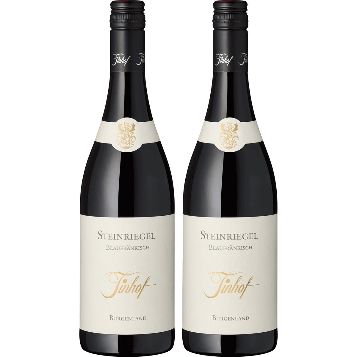 Zwei Flaschen österreichischer Rotwein der Sorte Blaufränkisch vom Weingut Tinhof aus dem Burgenland stehen nebeneinander. Die Etiketten sind elegant in Weiß und Gold gestaltet, die Flaschen haben schwarze Schraubverschlüsse. Das Produkt wirkt hochwertig und eignet sich als Geschenk oder für festliche Anlässe.