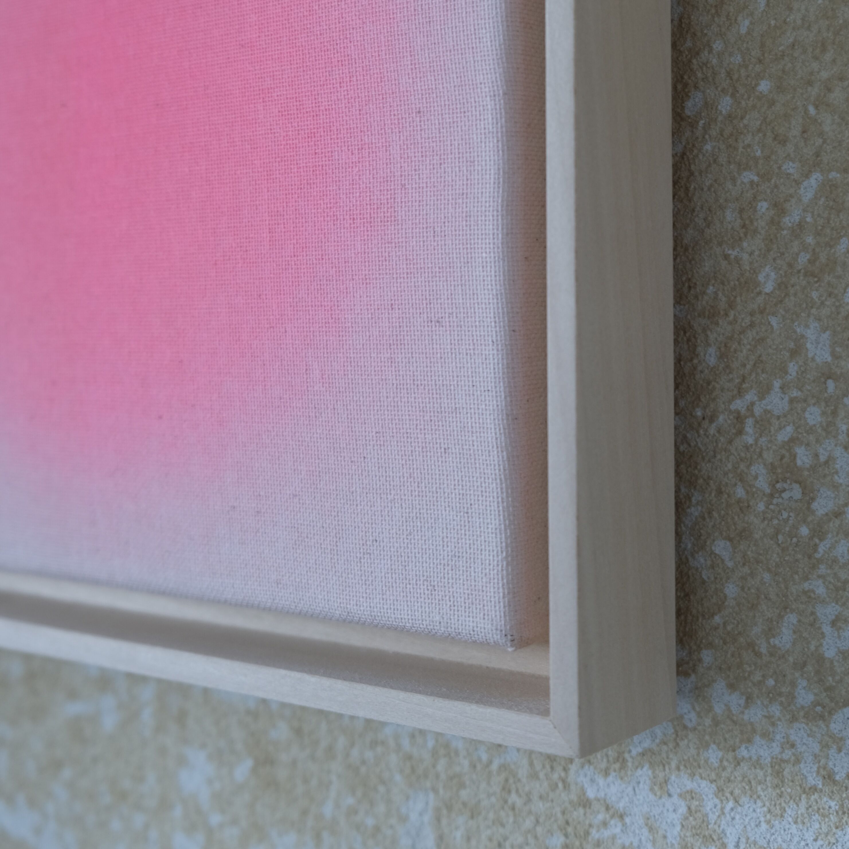 Detailaufnahme eines zeitgenössischen Kunstwerks aus der ZEIT-Sonderedition »Sorbet«, Apricot, von Anastasia Benko. Sichtbar ist ein sanft verlaufendes Apricot auf unbehandelter Leinwand im hellen Lindenholzrahmen vor beiger, strukturierter Wand.