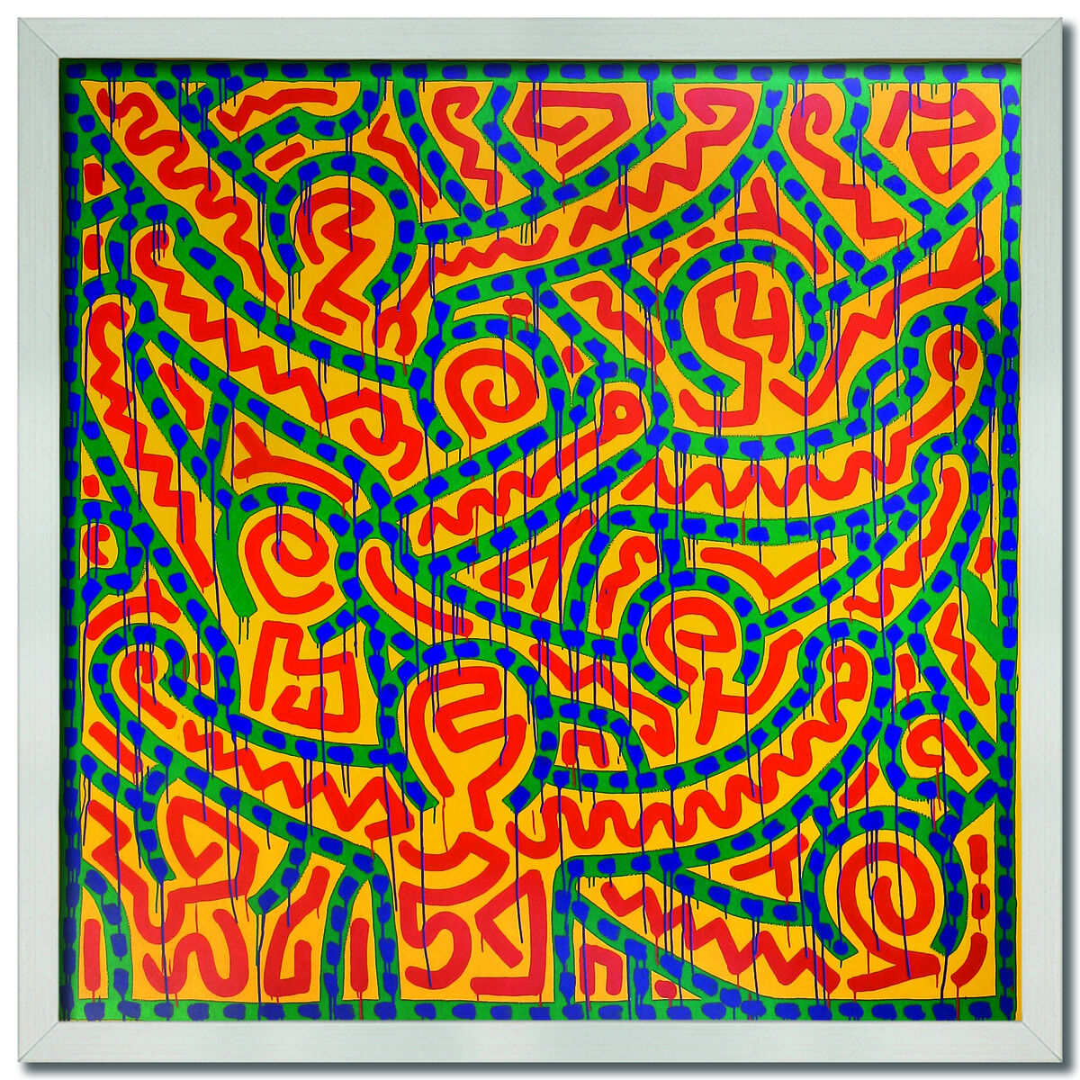 Ein gerahmtes Kunstwerk von Keith Haring mit dem Titel 'Untitled 1989'. Das Bild zeigt komplexe, farbenfrohe Muster in Gelb, Rot, Grün und Blau, typisch für Harings Stil der abstrakten und grafischen Kunst.