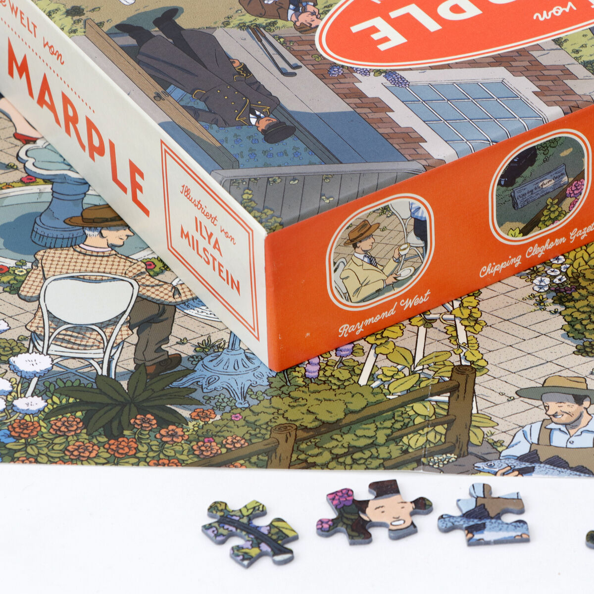 Ein Puzzle mit dem Titel »Die Welt von Miss Marple«, das eine Illustration von Szenen und Charakteren aus der Miss Marple-Serie zeigt. Das Bild zeigt Teile des Puzzles, eine Schachtel mit Beschriftung und mehrere zusammengesetzte Teile.