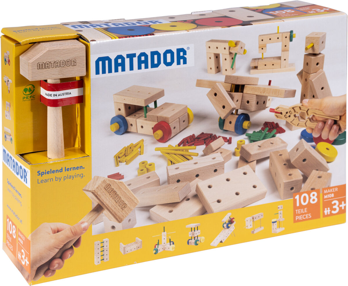 Holzkonstruktionsbaukasten »Maker M108«, 108-teilig von Matador. Der Baukasten zeigt verschiedene Holzbauteile und Werkzeuge, die in einer gelben und weißen Verpackung präsentiert werden. Das Spielzeug ist für Kinder ab 3 Jahren geeignet und unterstützt Kreativität und motorische Fähigkeiten.
