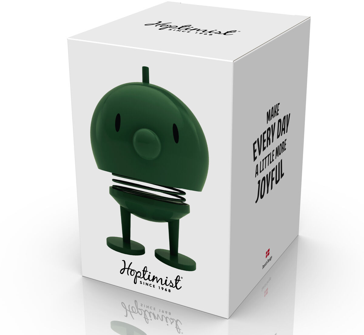 Die Verpackung der Hoptimist Bumble Pine Green Figur zeigt die grüne, runde Dekofigur mit Federbein und lächelndem Gesicht. Klare Produktaufnahmen auf weißem Hintergrund, seitlich ein motivierender Text: „Make every day a little more joyful“. Modernes, minimalistisches Design.