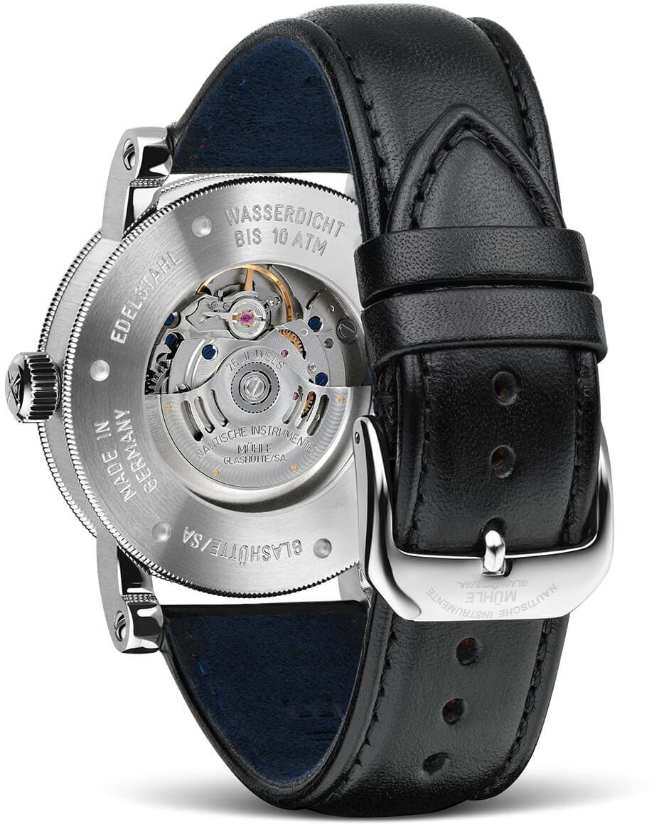 Rückseite der ZEIT-Sonderedition »Teutonia lll Automatik« Armbanduhr, die ein silbernes Gehäuse mit sichtbarem Uhrwerk und schwarzem Lederarmband zeigt.