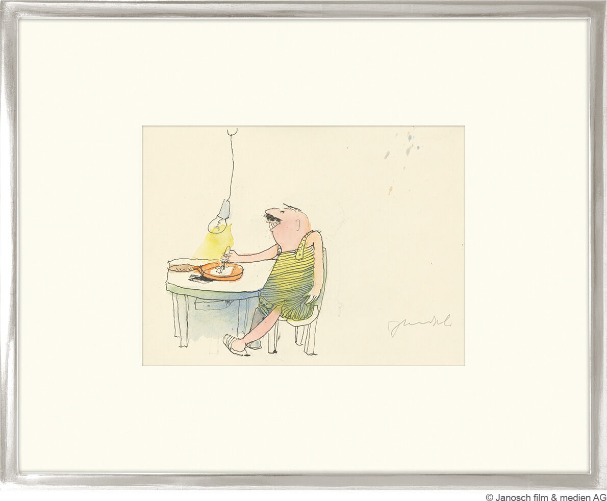 Eine Janosch-Illustration im Rahmen zeigt einen Bären im gestreiften Hemd, der an einem Tisch sitzt. Über ihm hängt eine beleuchtete Lampe, und vor ihm steht ein Teller mit Essen.