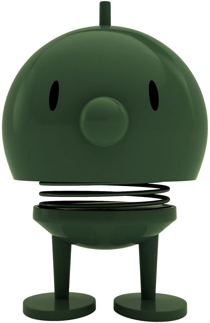 Die Hoptimist Bumble Pine Green Figur der Marke Hoptimist steht mittig vor weißem Hintergrund. Sie ist aus dunkelgrünem ABS-Kunststoff, hat eine runde Form, eine kleine Nase, zwei schwarze ovale Augen, einen federnden Mittelteil und zwei kurze Beine mit runden Füßen.