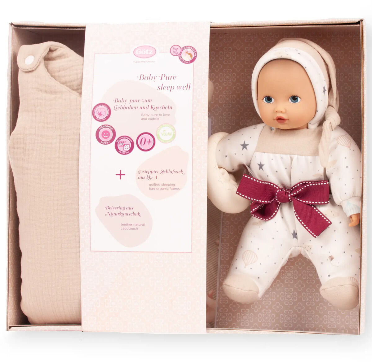 Geschenkbox mit einer weichen Baby-Schlafpuppe in Sternenanzug und Mütze sowie einem beigen Einschlagtuch. Die Puppe liegt rechts, das Einschlagtuch links, in einer geschmackvollen Verpackung mit Aufschrift 'Baby Pure sleep well'. Die Box vermittelt ein liebevolles, sicheres Schlafambiente für Neugeborene.