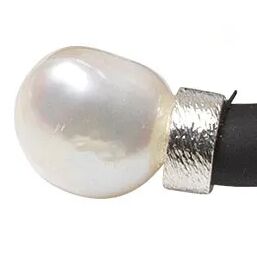 Nahaufnahme eines Rings aus dem Schmuckset "Mother of Pearl" von Ars mundi. Der Ring besteht aus einer großen, weißen Perle und einer breiten, strukturierten Fassung aus 925er-Sterlingsilber, die auf ein schwarzes Band aufgezogen ist. Hochwertige Materialien und eleganter Look.